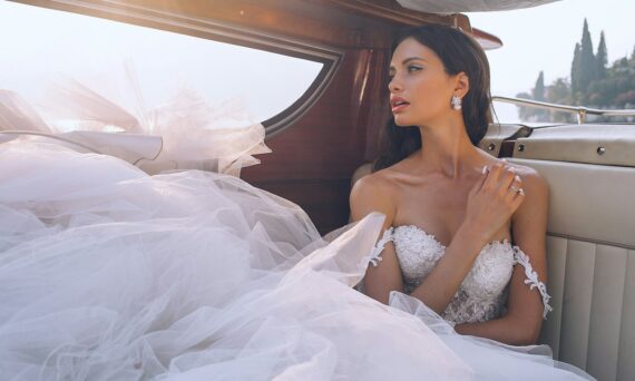 woman wearing white sweetheart-neckline wedding dress inside vehicle