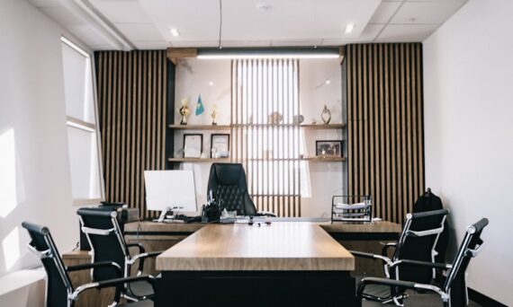 brown and black office table and four black cantilever chairs