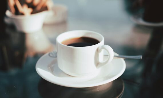 cup of coffee on white ceramic saucer