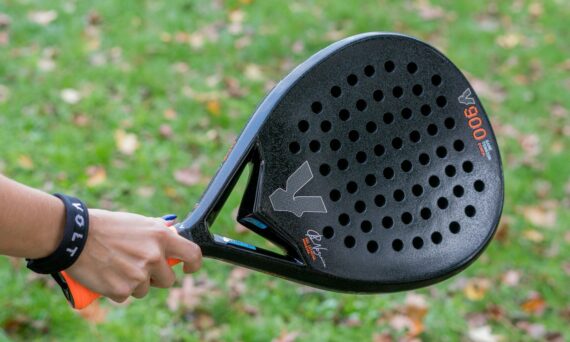A close up of a person holding a tennis racket
